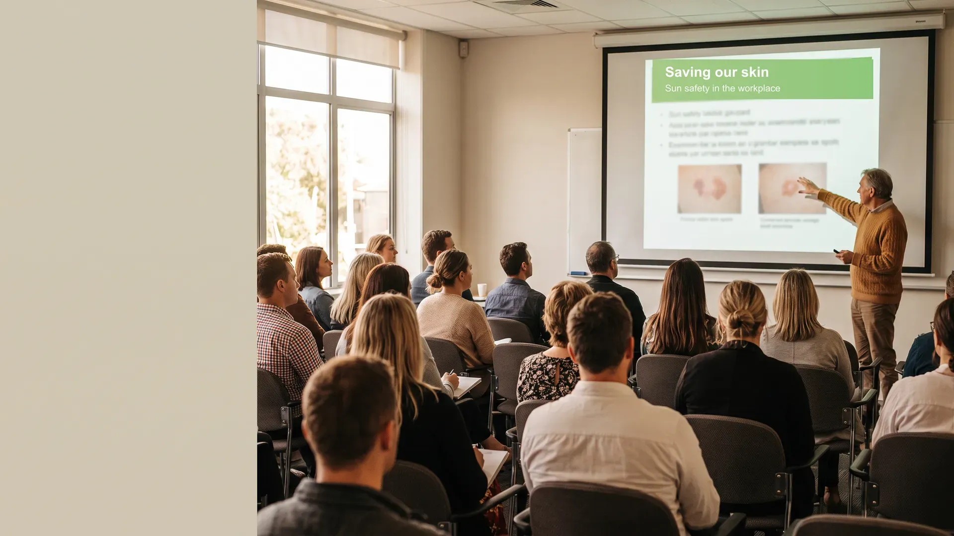 A workplace audience watching a Saving our Skin seminar presentation